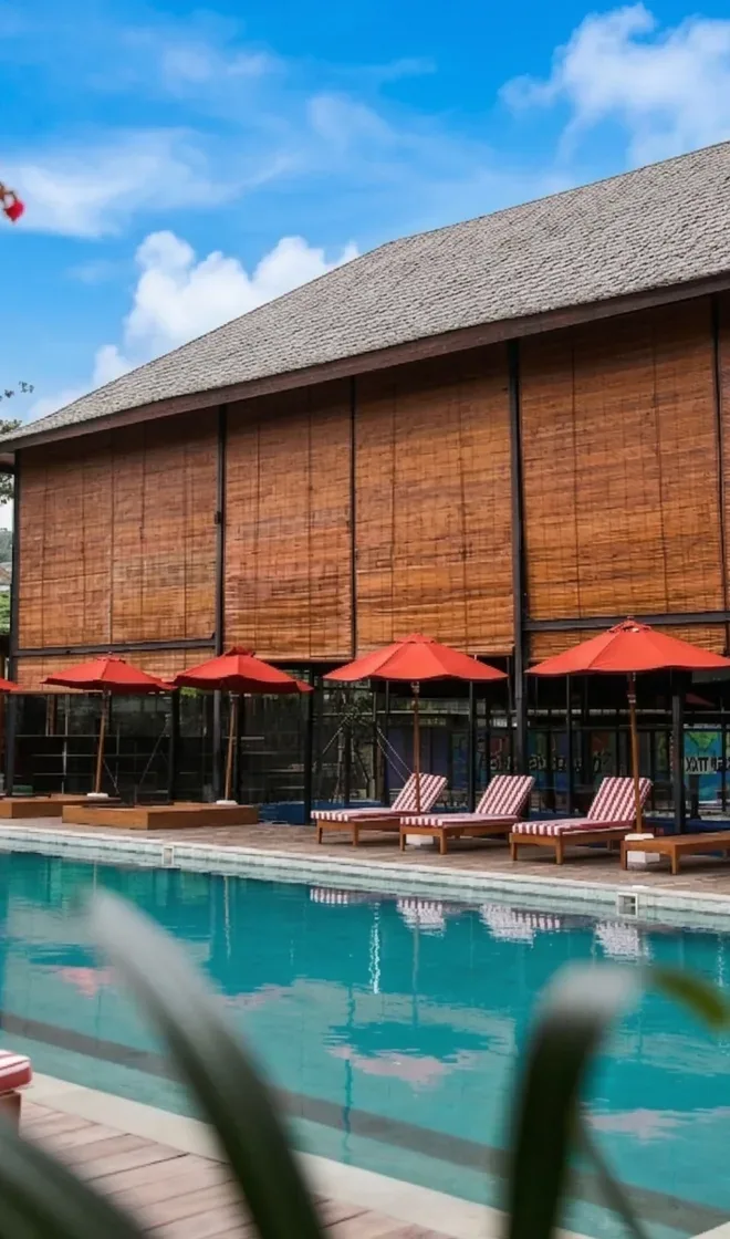 A thatched lodge by a pool in Bali
